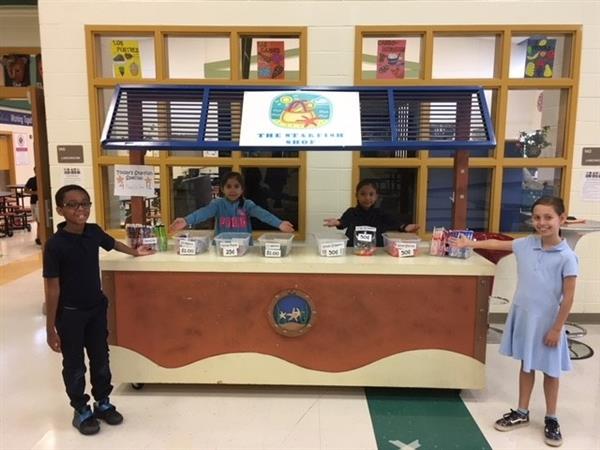 Young entrepreneurial students at the student-run school store